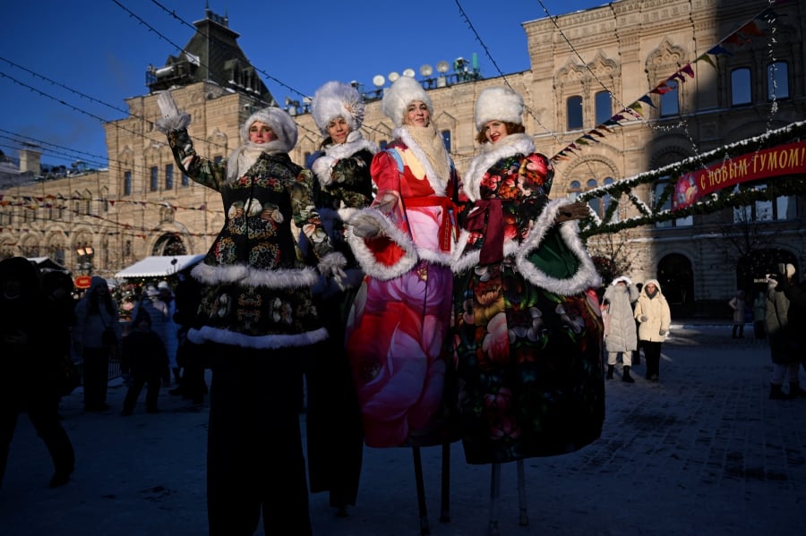 Artists walking on stilts as they perform in a square during Orthodox Christian Christmas celebrations in Moscow, on January 7, 2024. -AFP/NATALIA KOLESNIKOVA