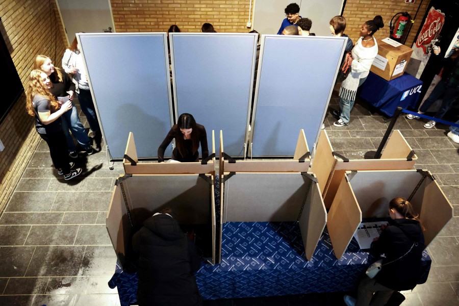 Students mark their ballots at a mock polling station at UCLouvain university campus on February 14, 2024 in Mons during a voting practice ahead of EU and national elections. 1900 Belgian students at three UCLouvain campuses stage a practice day of voting ahead of EU and national elections happening in June 2024. -AFP/Kenzo TRIBOUILLARD