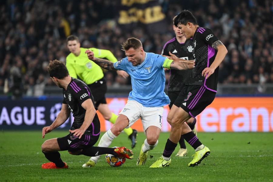 Lazio's Italian forward #17 Ciro Immobile fights for the ball with Bayern Munich's German midfielder #08 Leon Goretzka (left) and Bayern Munich's South Korean defender #03 Kim Min-Jae during the UEFA Champions League last 16 first leg between Lazio and Bayern Munich at the Olympic stadium in Rome. -AFP/Alberto PIZZOLI