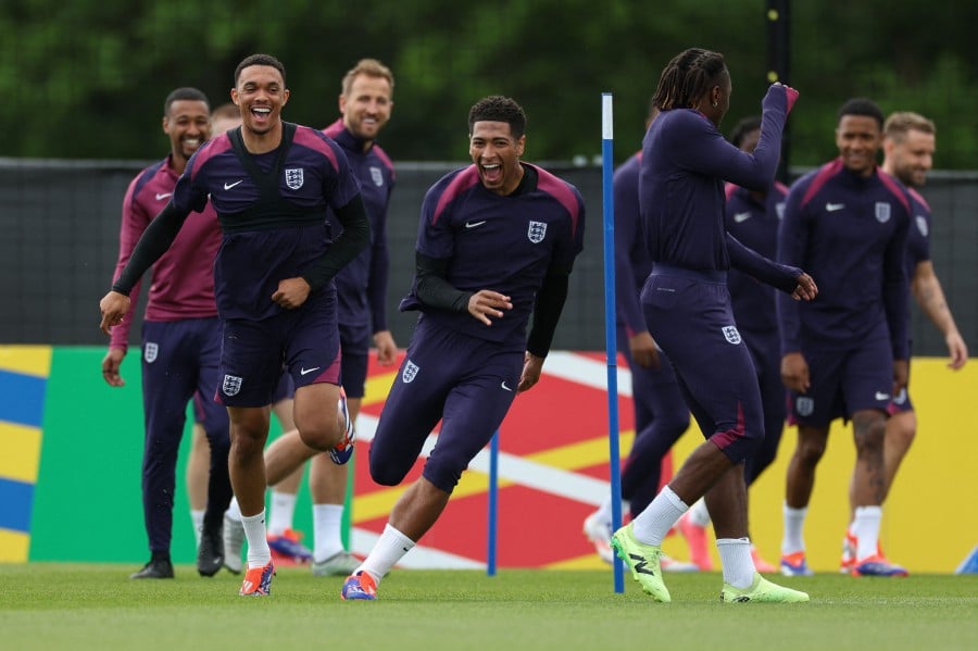 England's midfielder #10 Jude Bellingham (centre) takes part in a training session next to England's defender #08 Trent Alexander-Arnold (left) and England's forward #21 Eberechi Eze during the UEFA Euro 2024 European football Championship, in Blankenhain, eastern Germany. -AFP/Adrian DENNIS