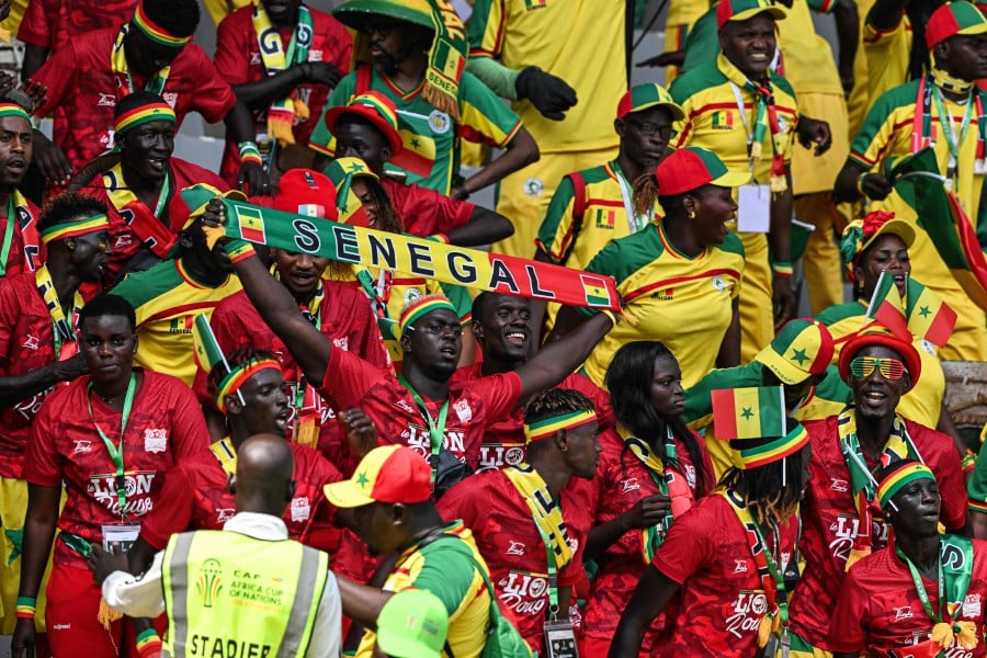 Senegal's supporters wave during the Africa Cup of Nations (CAN) 2024 group C football match between Senegal and Gambia at Stade Charles Konan Banny in Yamoussoukro. -AFP/Issouf SANOGO