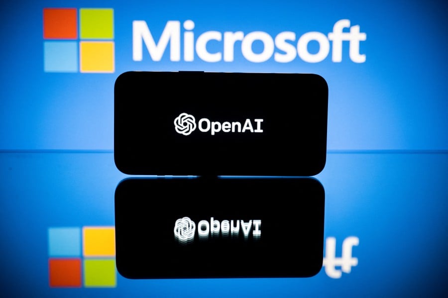 This picture shows screens displaying the logos of Microsoft and OpenAI. Microsoft-backed OpenAI is working on a software that can generate minute-long videos based on text prompts. -AFP/Lionel BONAVENTURE