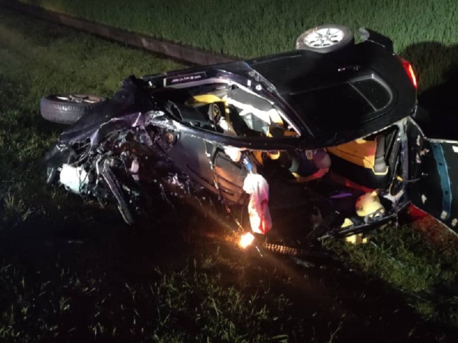 Two friends died when the car they were travelling in was involved in a fatal crash at Jalan Sungai Lokan. -PIC COURTESY OF FIRE AND RESCUE DEPARTMENT