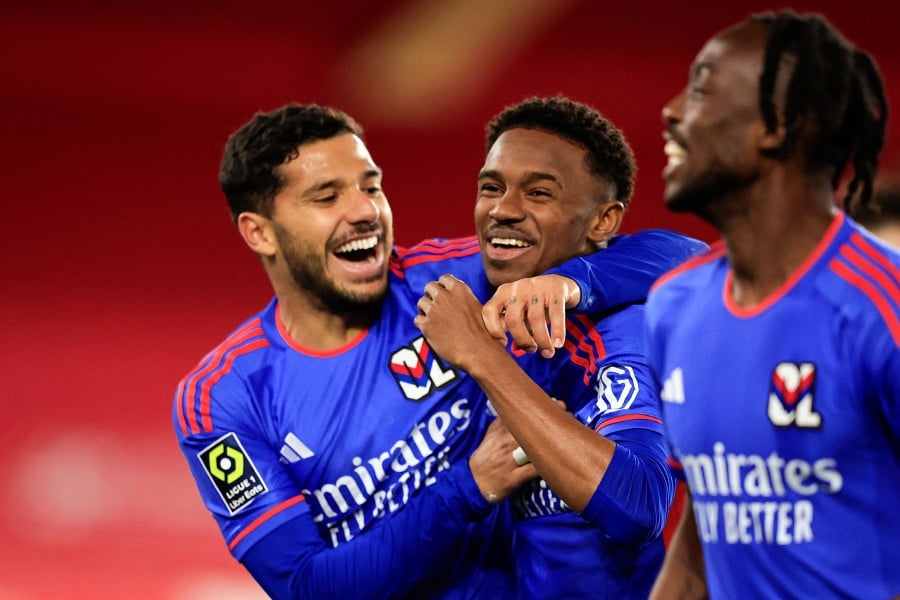 Lyon's Brazilian forward #47 Jeffinho (centre) celebrates with teammates after scoring the first goal for his team during the French L1 football match between Monaco (AS Monaco) and Olympique Lyonnais (Lyon) at the Louis II Stadium (Stade Louis II) in the Principality of Monaco, on December 15, 2023. -AFP/Valery HACHE