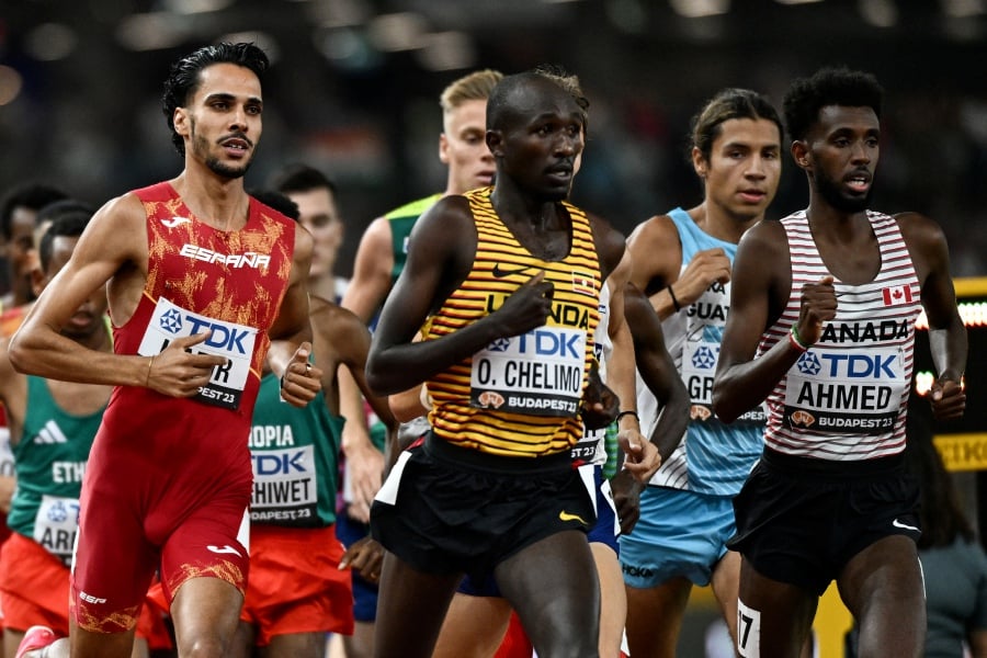 (FILE PHOTO) Spain's Mohamed Katir (left) and other athletes compete in the men's 5000m final during the World Athletics Championships at the National Athletics Centre in Budapest on August 27, 2023. Mohammed Katir will miss the Olympics later this year after being suspended for two years by the Athletics Integrity Unit (AIU). -AFP/Jewel SAMAD