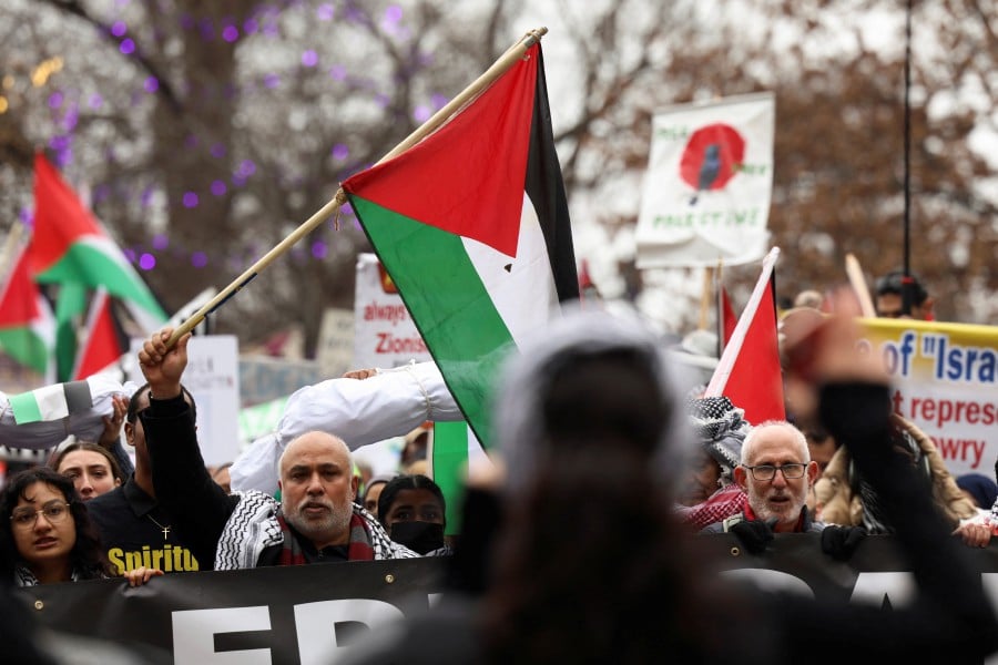 Demonstrators march at a rally held by the Boston Coalition for Palestine, calling for a permanent cease-fire in Gaza in Boston, Massachusetts, US, December 17, 2023. -REUTERS/Reba Saldanha