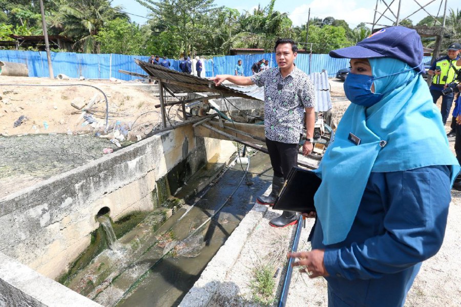 BUKIT MERTAJAM: State Agrotechnology, Food Security and Cooperative Development Committee chairman Fahmi Zainol (Left) together with state Veterinary Services Department (DVS) director Dr Saira Banu Mohamed Rejab look at waste water from a duck farm flowing towards the river while carrying out an inspection at a duck farm in Sungai Lembu. -NSTP/DANIAL SAAD