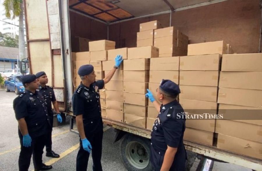 Muar police confiscate 451 boxes labelled as Knight General, valued at RM129,888 without taxes, and bags of suspected alcohol essence valued at RM26,000. -NSTP/ALIAS ABD RANI