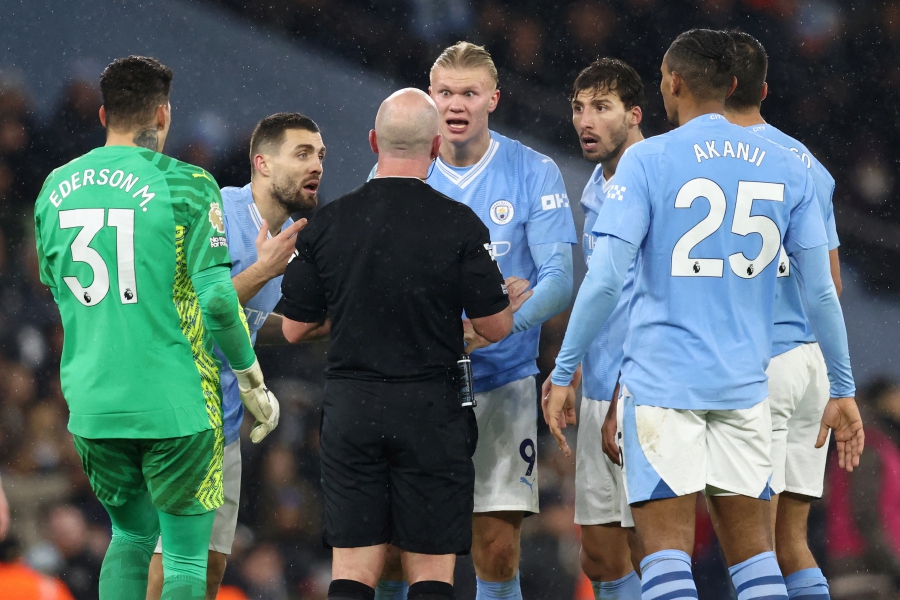 Manchester City's players appeal to English referee Simon Hooper during the English Premier League football match between Manchester City and Tottenham Hotspur at the Etihad Stadium in Manchester, northwest England, on December 3, 2023. Manchester City have been fined £120,000 (RM711,451) by the Football Association after their players surrounded a match official during their dramatic 3-3 draw against Tottenham Hotspur. -AFP/Darren Staples