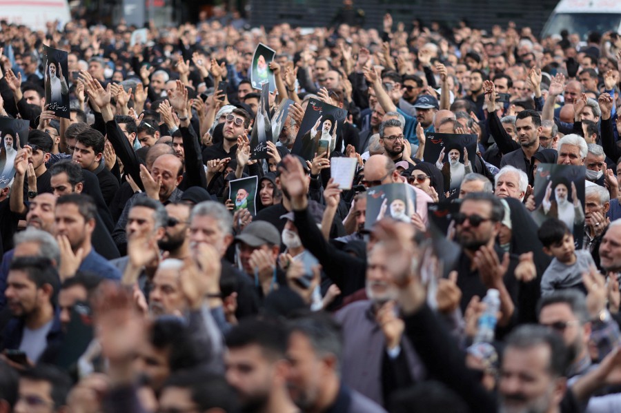 People gather to mourn for the death of the late Iran's President Ebrahim Raisi, in Tehran, Iran. -REUTERS/Majid Asgaripour/WANA