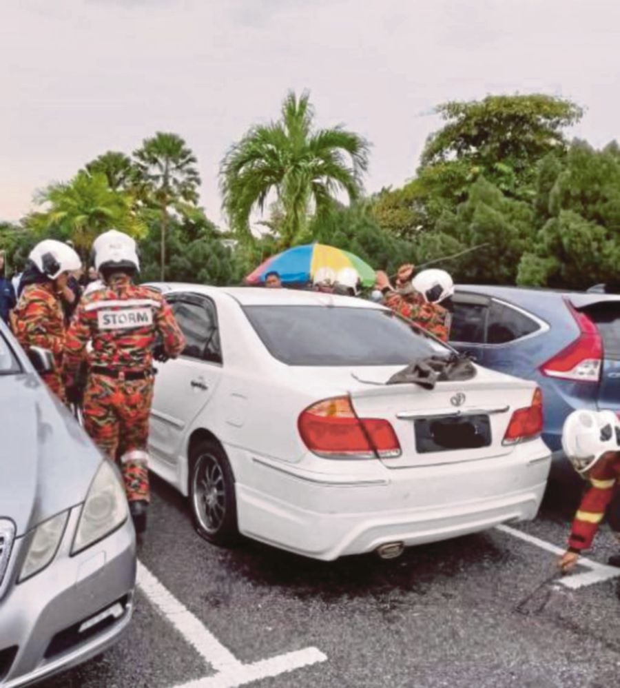 A woman was found dead in her car at Ipoh’s Raja Permaisuri Bainun Hospital parking lot on Tuesday. -PIC COURTESY OF FIRE AND RESCUE DEPARTMENT