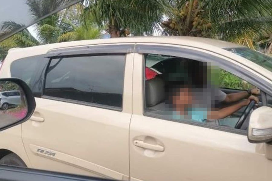 Police have taken action against a man who allowed a teenager to be behind the wheel of a car, as seen in a photo that went viral on social media. -VIRAL PIC