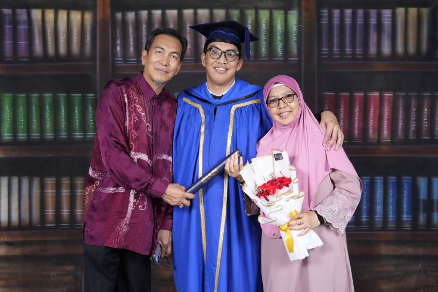 Muhammad Amirul Asyraf Md Asri, a 31-year-old from Lahad Datu, Sabah, who has dystonic cerebral palsy, attained his long-awaited Bachelor of Law degree from Universiti Utara Malaysia after seven years of diligent study. -COURTESY PIC