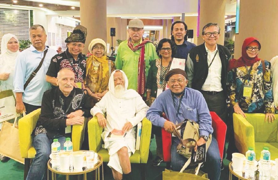 The writer (left, front row) with some of the festival participants and Raja Ahmad standing in the centre (green shirt). -PIC COURTESY OF WRITER