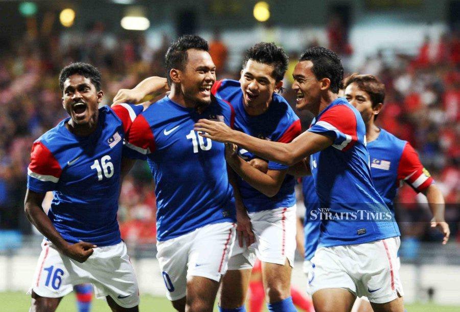 (FILE PHOTO) Safee Sali (two from left) and his Harimau Malaya teammates celebrating his goal. -NSTP FILE