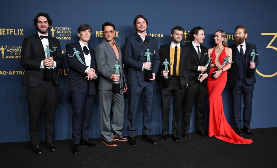 (From left to right) Benny Safdie, Cillian Murphy, Robert Downey Jr., Josh Hartnett, Alden Ehrenreich, Casey Affleck, Emily Blunt and Kenneth Branagh, winner of the Outstanding Performance by a Cast in a Motion Picture award for 'Oppenheimer' pose in the press room during the 30th Annual Screen Actors Guild Awards at the Shrine Auditorium in Los Angeles, February 24, 2024. -AFP/Robyn BECK