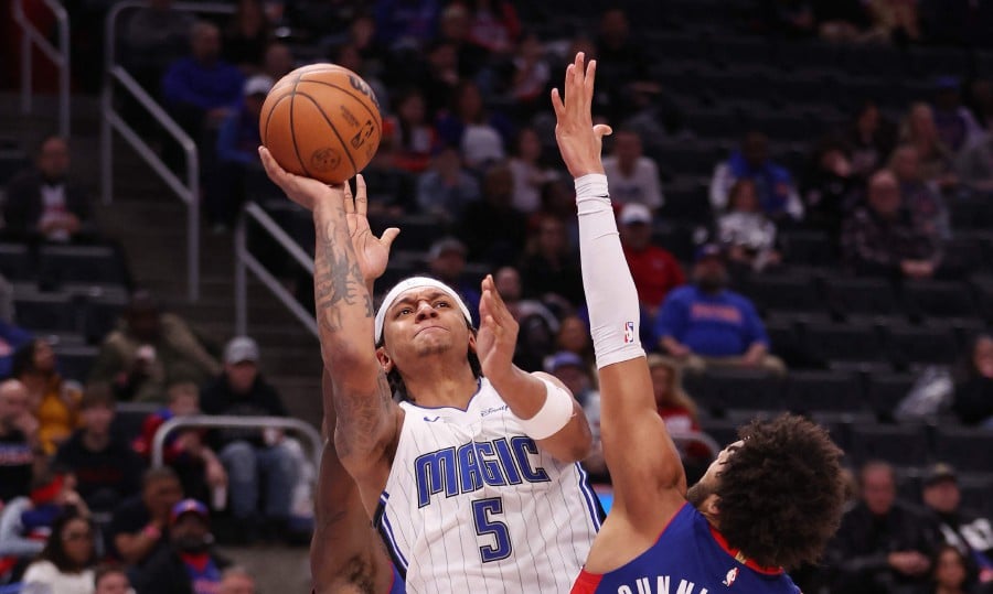 Paolo Banchero (5) of the Orlando Magic gets a shot off around Cade Cunningham (2) of the Detroit Pistons during the second half at Little Caesars Arena in Detroit, Michigan. Orlando won the game 112-109. -AFP/Gregory Shamus
