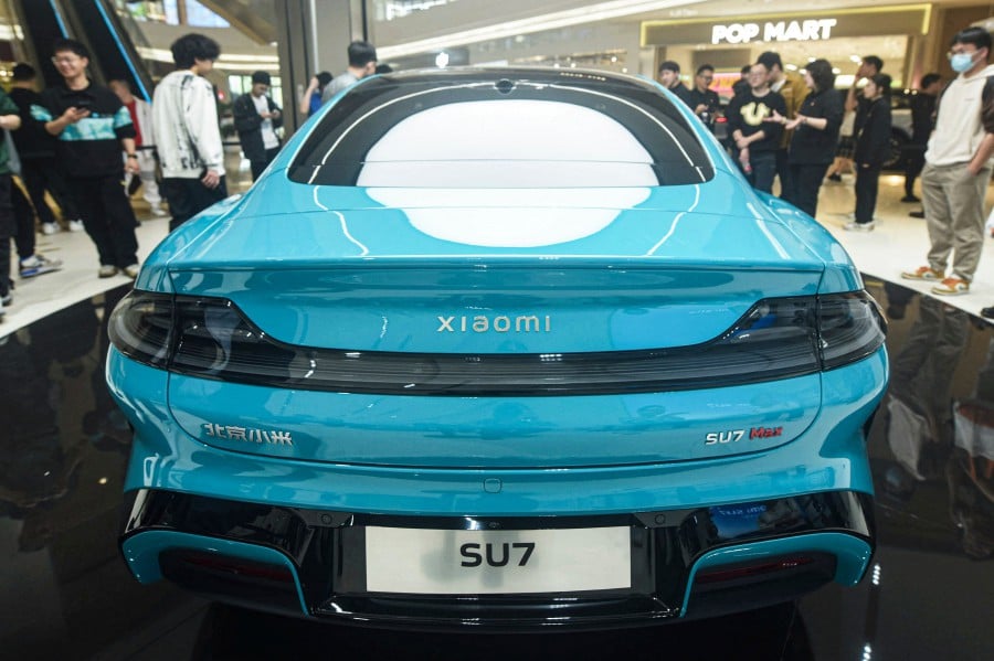 Chinese smartphone maker Xiaomi's first electric car, Xiaomi SU7 model, is seen at a shop in Hangzhou, in eastern China's Zhejiang province. -AFP/China OUT