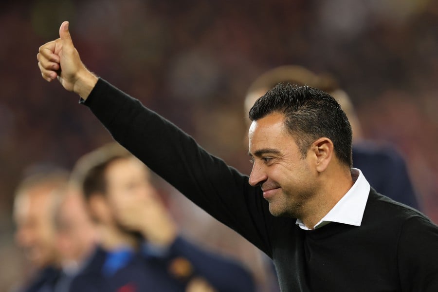 (FILE PHOTO) Barcelona's Spanish coach Xavi gestures after the Spanish league football match. Xavi is to remain Barcelona's coach according to the club. -AFP/Lluis GENE