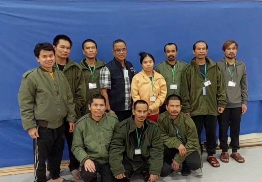 Thai workers taken hostage by Hamas and later released as part of the deal, pose with a member of Thai mission after a medical checkup, in Tel Aviv, Israel. -REUTERS/Ministry Of Foreign Affairs Thailand/Handout