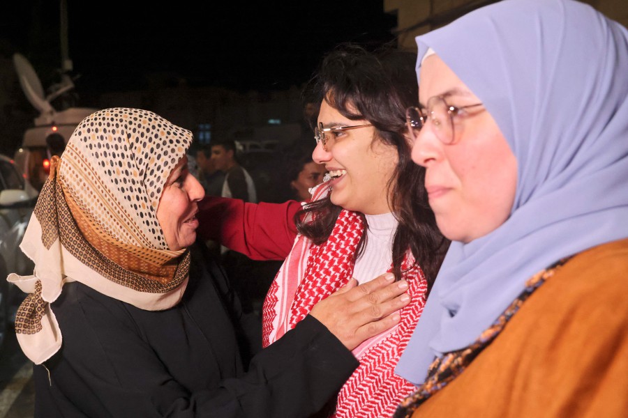 Hanin Barghouti (centre) a Palestinian prisoner held in an Israeli prison is greeted by her family on her release under a truce deal between Israel and Hamas in exchange for hostages held in Gaza, in Baytunia in the occupied West Bank on November 24, 2023. -AFP/AHMAD GHARABLI