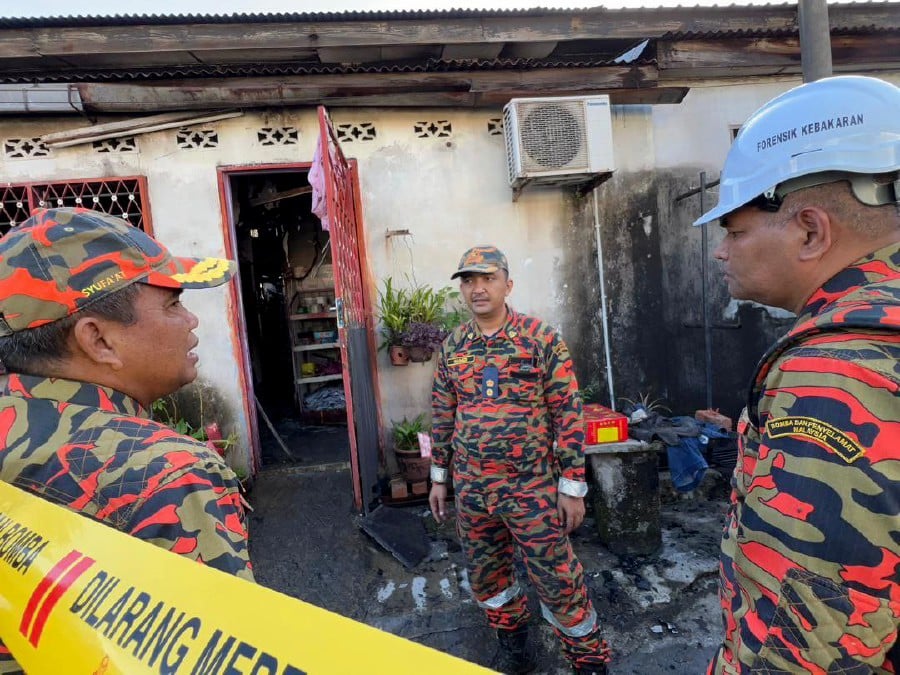 The son of the motorcycle shop owner died in a fire at the premises in Taman Sri Utama in Gurun, Kedah. -PIC COURTESY OF FIRE AND RESCUE DEPARTMENT