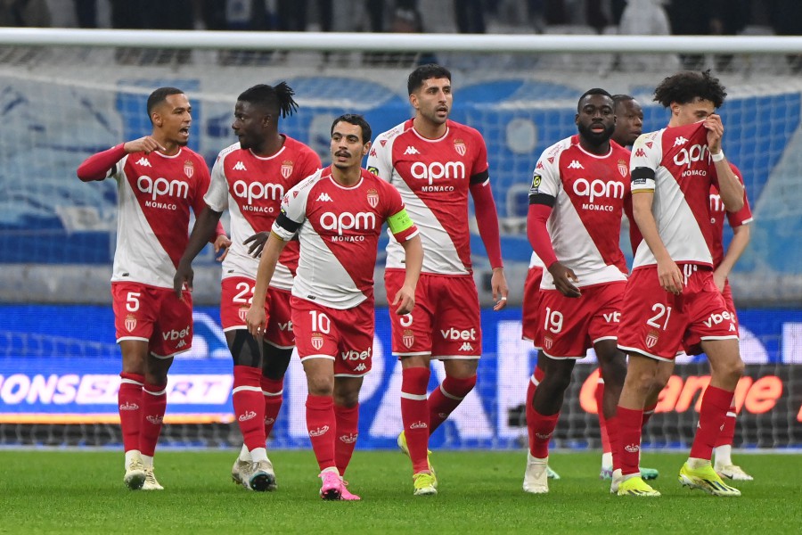 Monaco's French forward #10 Wissam Ben Yedder is congratulated by his teammates after scoring a goal during the French L1 football match between Olympique de Marseille (OM) and AS Monaco at the Orange Velodrome Stadium in Marseille, south-eastern France. -AFP/Sylvain THOMAS