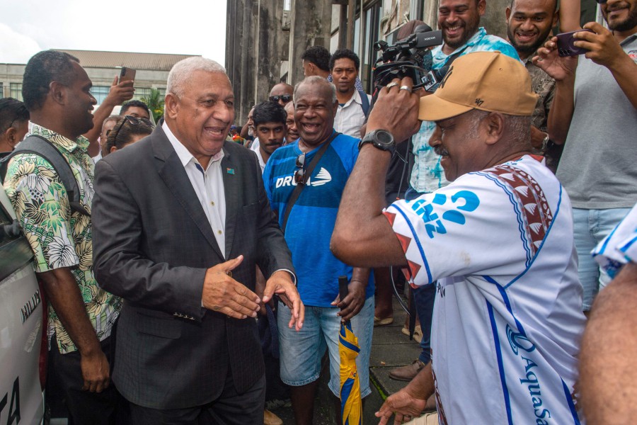 Fiji's former prime minister Frank Bainimarama (centre) reacts with his supporters as he leaves the Magistrates Court in Suva. Bainimarama avoided jail time despite being found guilty of perverting the course of justice while leading the South Pacific island nation. -AFP/LEON LORD