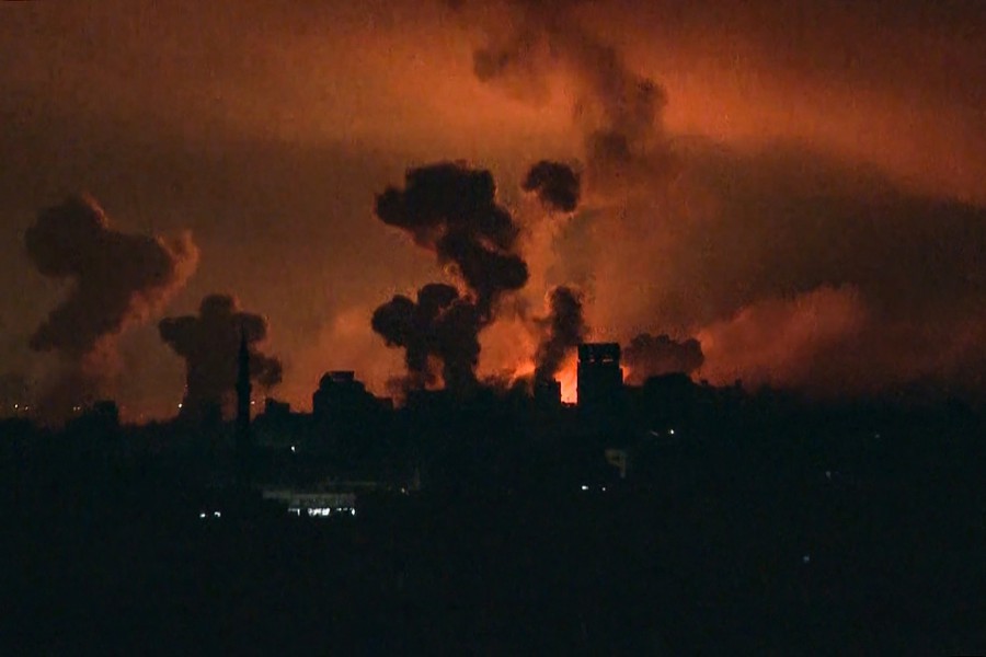 This image grab from an AFP TV footage shows fire and smoke rising above Gaza City during an Israeli strike on October 27, 2023. The Israeli army on the evening of October 27 carried out bombings of "unprecedented" intensity since the start of the war in the north of the Gaza Strip, particularly in Gaza City. -AFP/Yousef Hassouna
