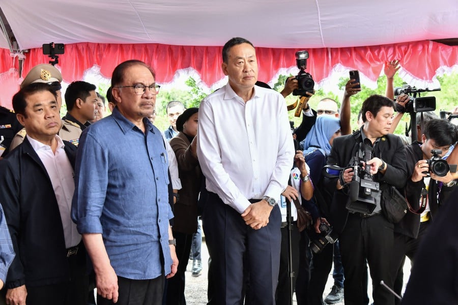 Prime Minister Anwar Ibrahim and Thailand's Prime Minister Srettha Thavisin (centre) assessing a development project near the Malaysia-Thai border in Sadao. -AFP/HO/ROYAL THAI GOVERNMENT