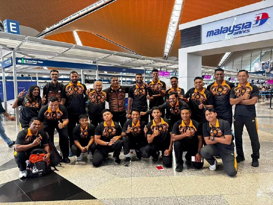 Malaysian players and officials pose for a photo at KLIA before their flight to Kathmandu for the World Cup qualifiers on Saturday. -PIC COURTESY OF MCA