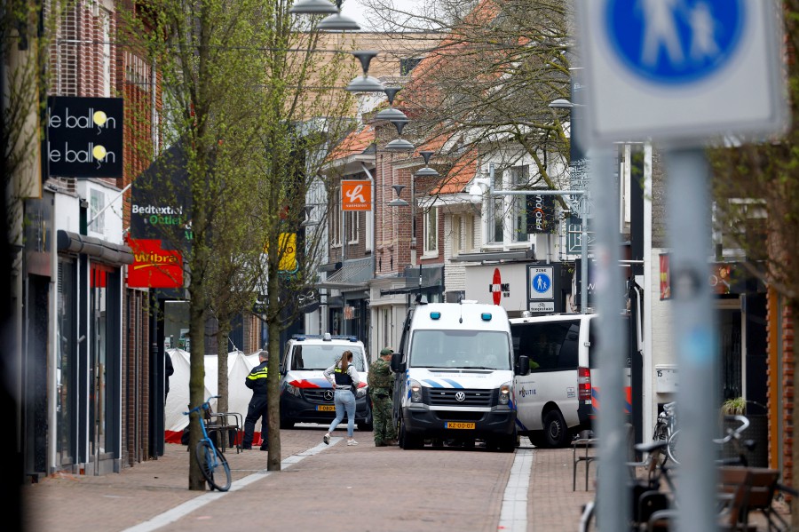 Dutch police officers work near the Cafe Petticoat, where several people are being held hostage in Ede, Netherlands March 30, 2024. -REUTERS/Piroschka Van De Wouw