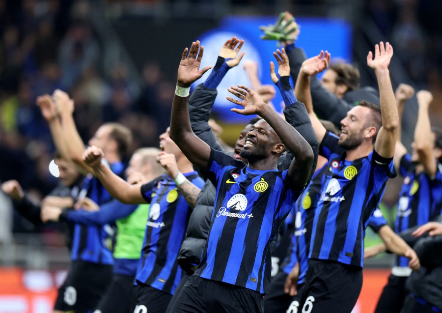 Inter Milan's Marcus Thuram celebrates with teammates in front of their fans after the match. -REUTERS/Claudia Greco