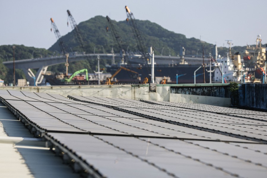 Thin-film solar cell devices, designed to convert light energy into electrical energy, lying on top of a building at Port of Suao in Yilan County. -AFP/I-Hwa CHENG