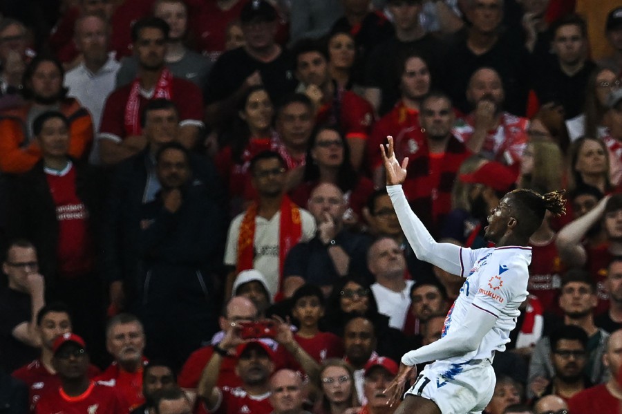 Crystal Palace's Ivorian striker Wilfried Zaha celebrates after scoring his team first goal during the English Premier League football match between Liverpool and Crystal Palace at Anfield stadium, in Liverpool. - AFP PIC