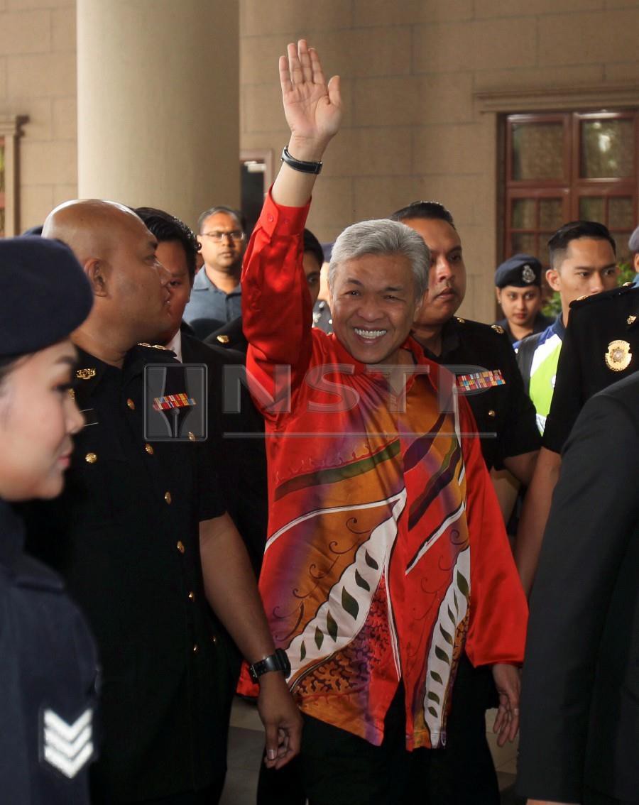 Datuk Seri Dr Ahmad Zahid Hamidi waves at supporters at the Kuala Lumpur High Court where he was later slapped with 45 charges of CBT, graft and money laundering. BERNAMA picture