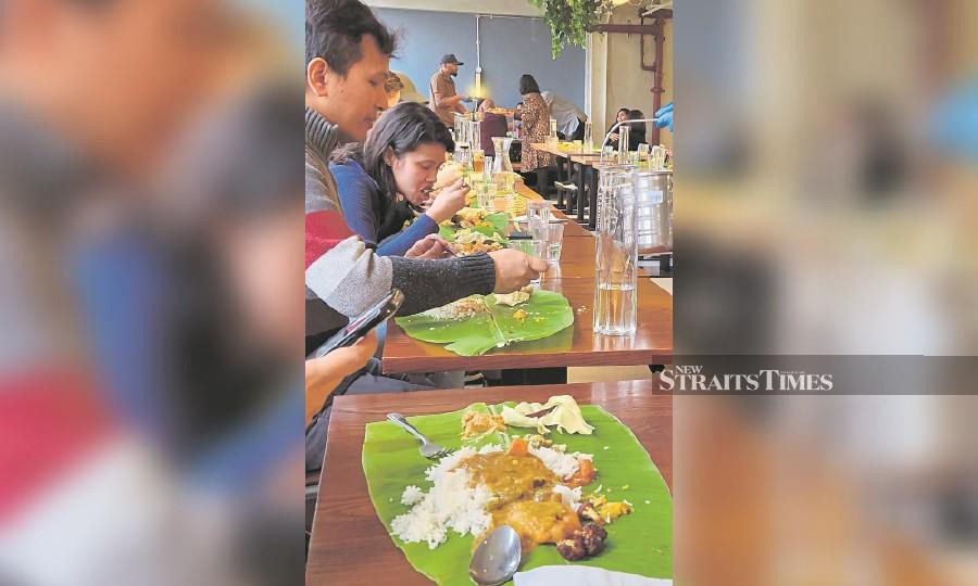 Customers enjoying a vegetarian meal at Gopal’s Corner in Oxford Circus, London, during Pongal. -NSTP/ZAHARAH OTHMAN