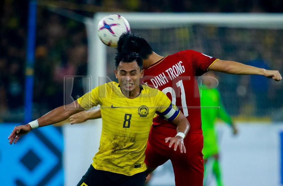 Malaysia’s Zaquan Adha Radzak in action against Vietnam’s Tran Dinh Trong during the match at the National Stadium Bukit Jalil. - NSTP/ASYRAF HAMZAH