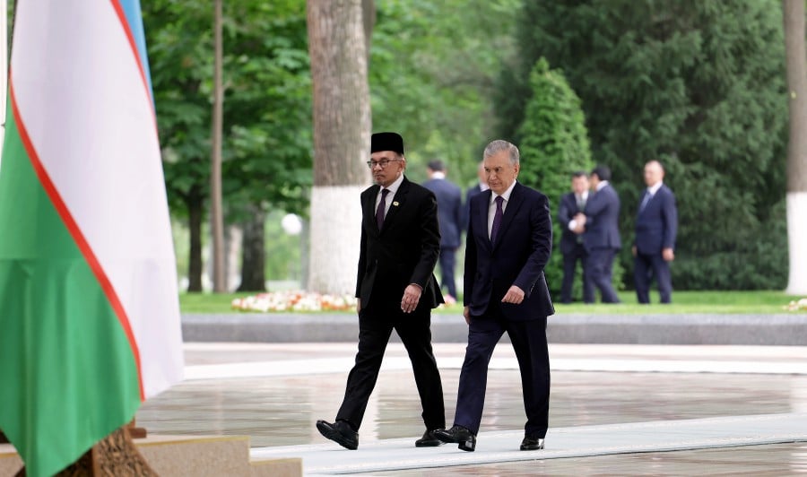 Prime Minister Datuk Seri Anwar Ibrahim, accompanied by the President of Uzbekistan Shavkat Mirziyoyev during the official welcoming ceremony at the Presidential Palace Kuksaroy in conjunction with his official visit to Uzbekistan. -- BERNAMA PIC