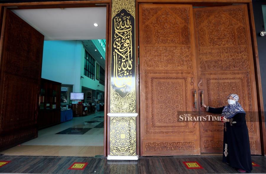 The giant doors that open up to the lobby of the Selangor International Islamic Arts Complex are heavily adorned with intricate wood cavings.