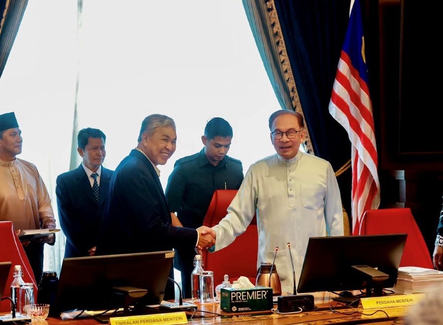 Prime Minister Datuk Seri Anwar Ibrahim shakes hand with his deputy, Datuk Seri Dr Ahmad Zahid Hamidi (left) during the cabinet meeting. - Pic credit Facebook zahidhamidi.fanpage